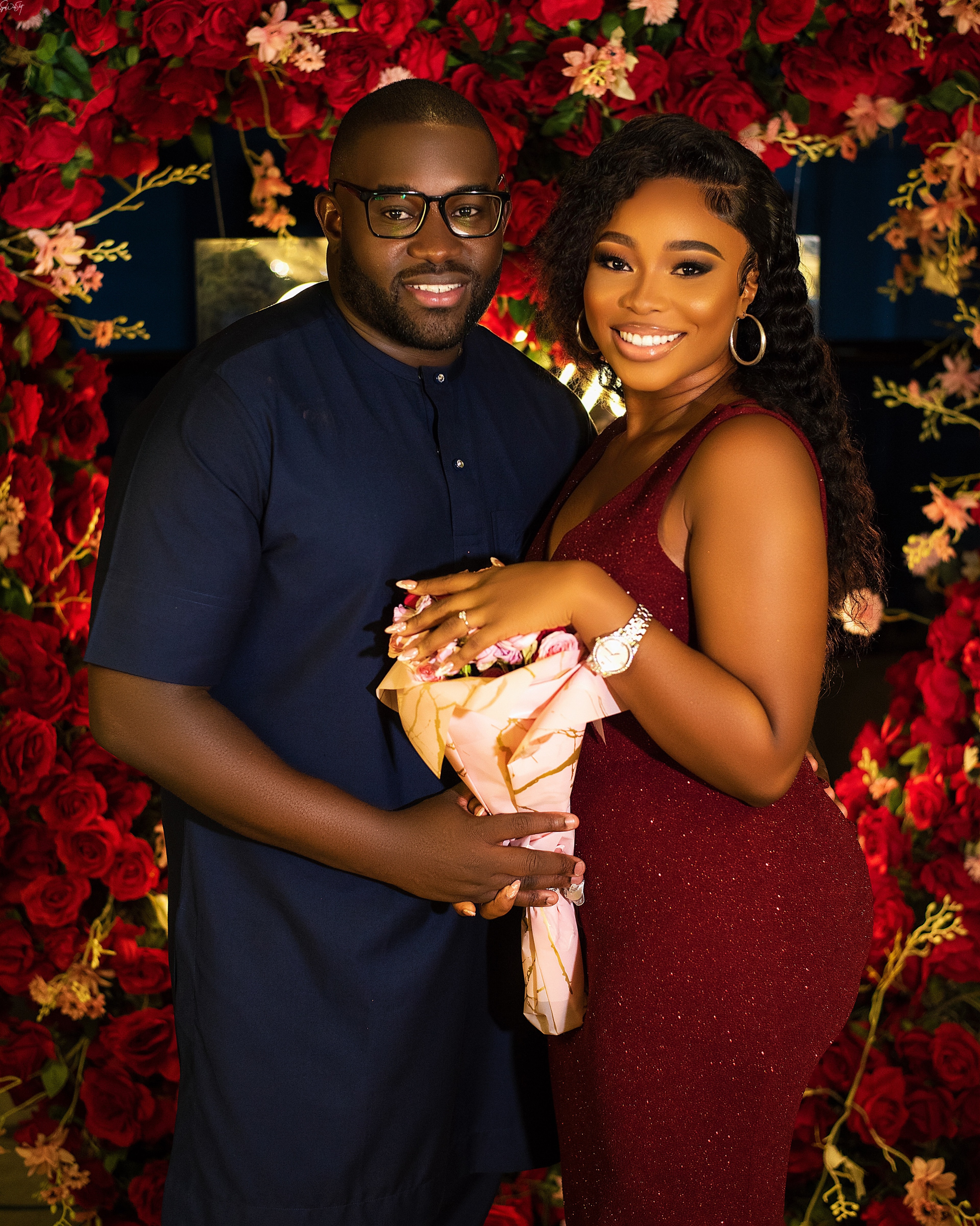 Elegant formal wear with red rose backdrop
